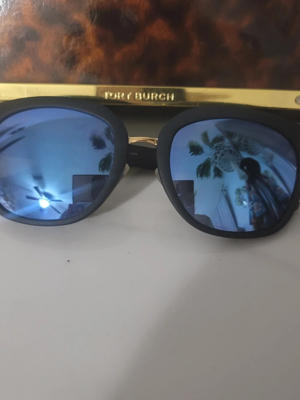 Tory Burch Black Frame Sunglasses with Blue Mirrored Lenses